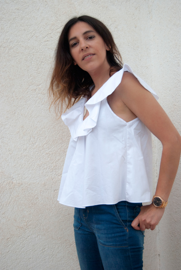 Camisa blanca de algodón con volante en el escote de Zara, complementado con jeans acampanados y sandalias de Zara. White cotton shirt with ruffle on the neckline of Zara, complemented by flared jeans and Zara sandals.